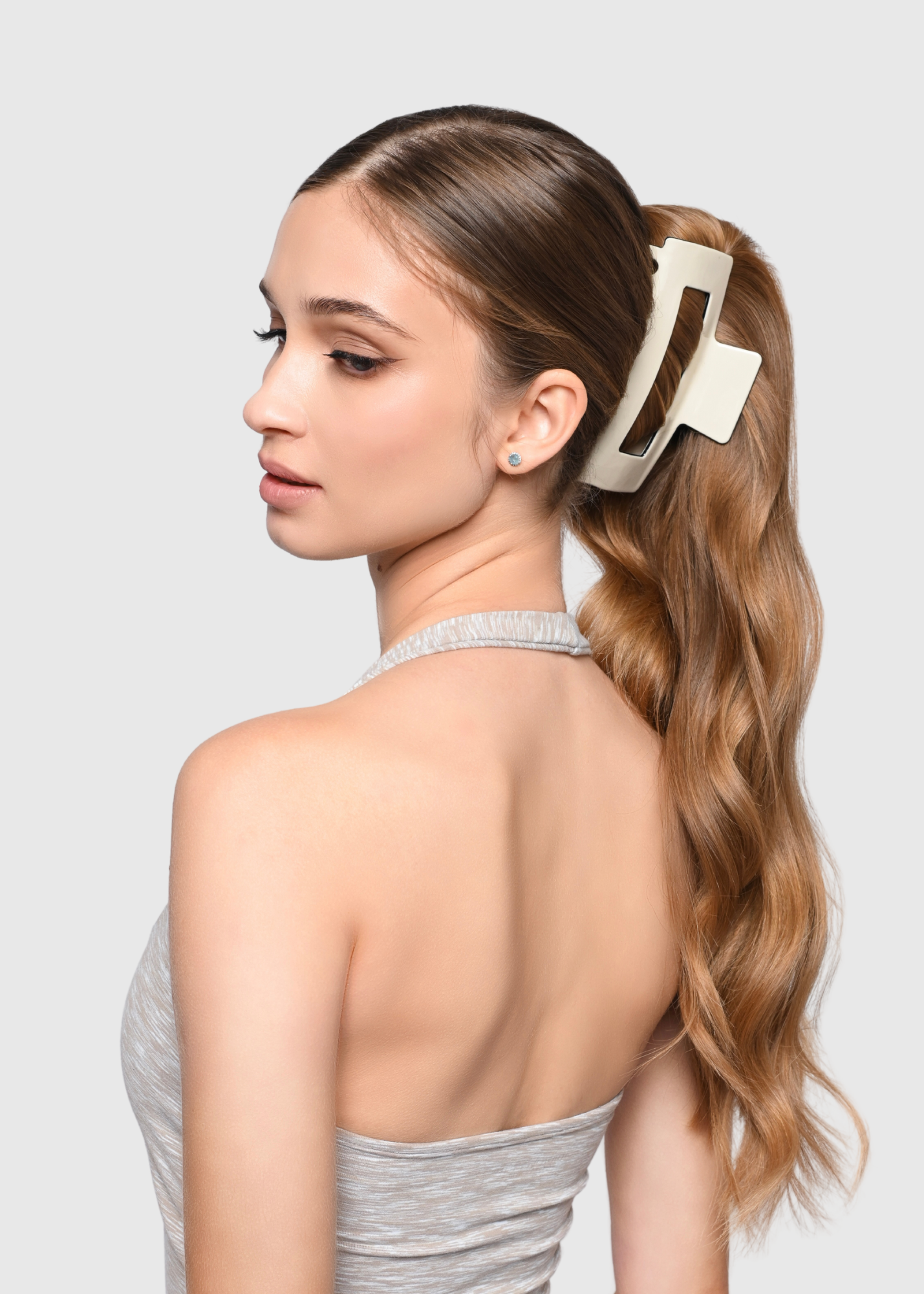 Extra large white claw clip styled on model in ponytail style