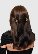 Load image into Gallery viewer, small gold metal claw clip set styled in half do
