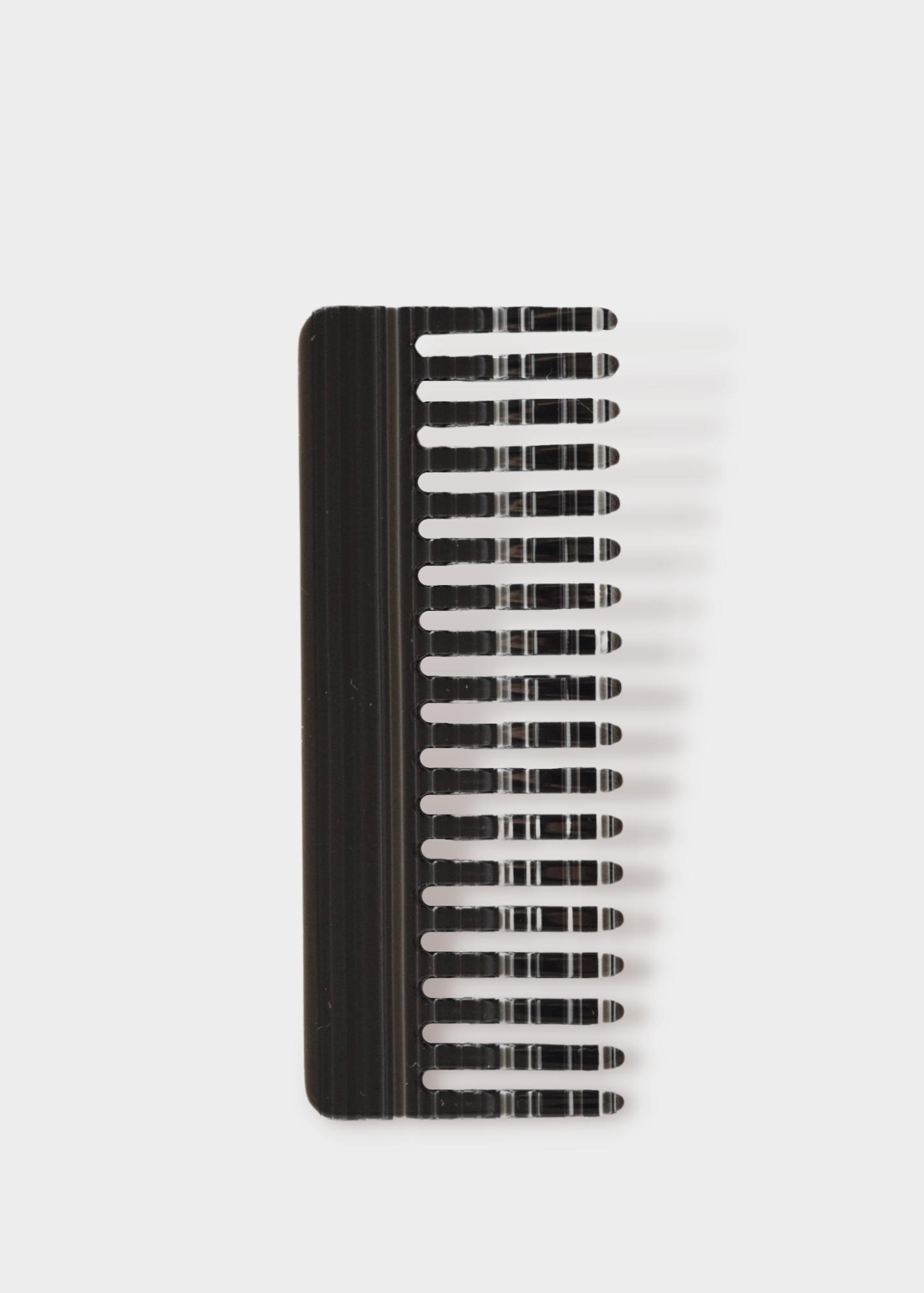 Wide tooth shower comb, with horizontal black and white stripes