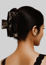 Load image into Gallery viewer, large black wavy claw clip in full updo hairstyle on thick black hair
