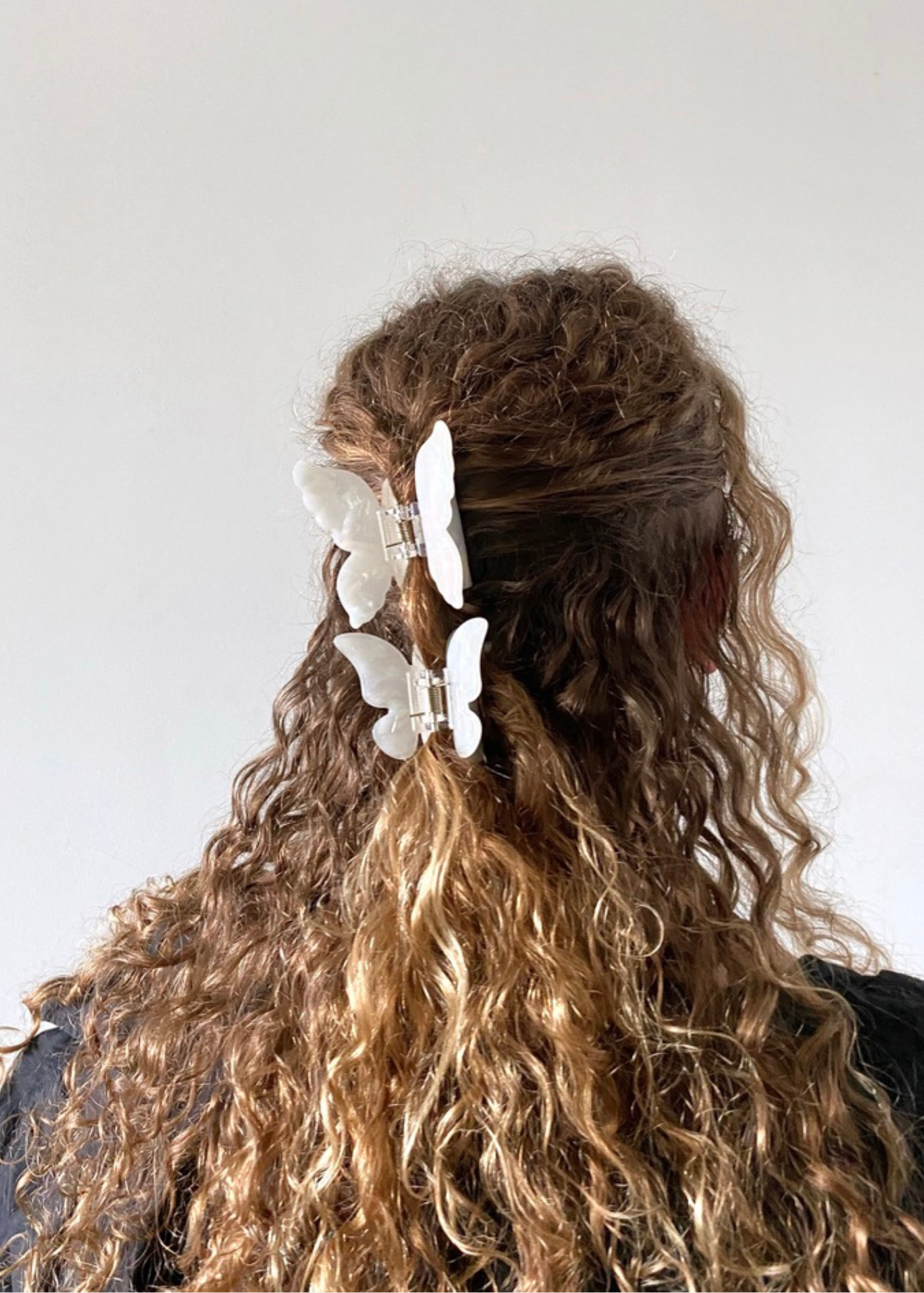White Butterfly Clip set on curly hair