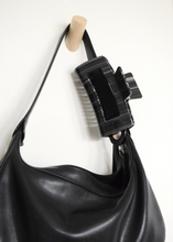 Load image into Gallery viewer, extra large black striped claw clip clipped on black purse
